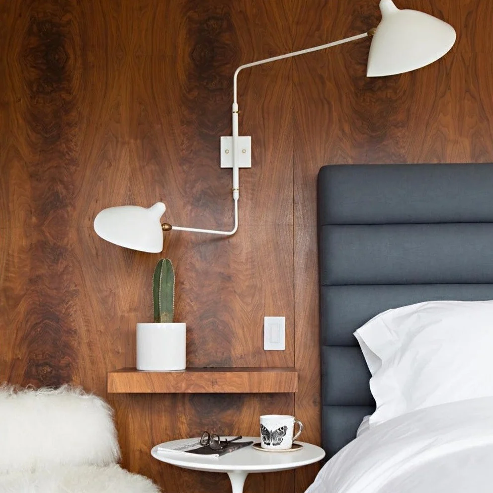 White two head wall light by bed