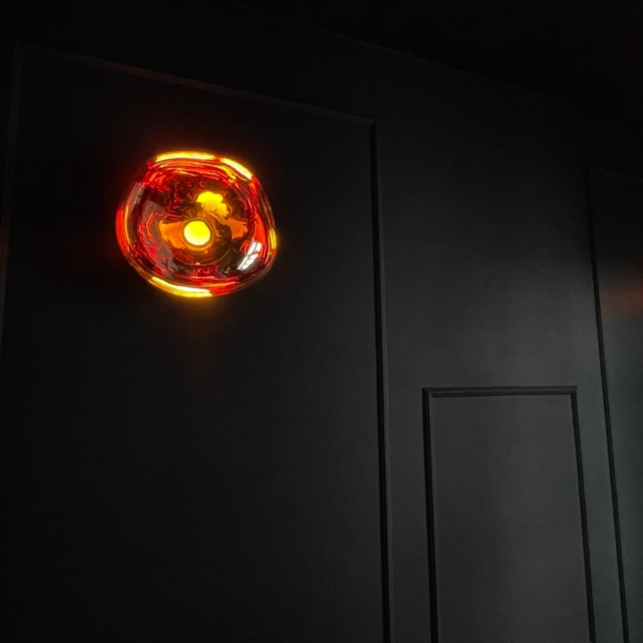 Customer photo of amber wall lamp at night