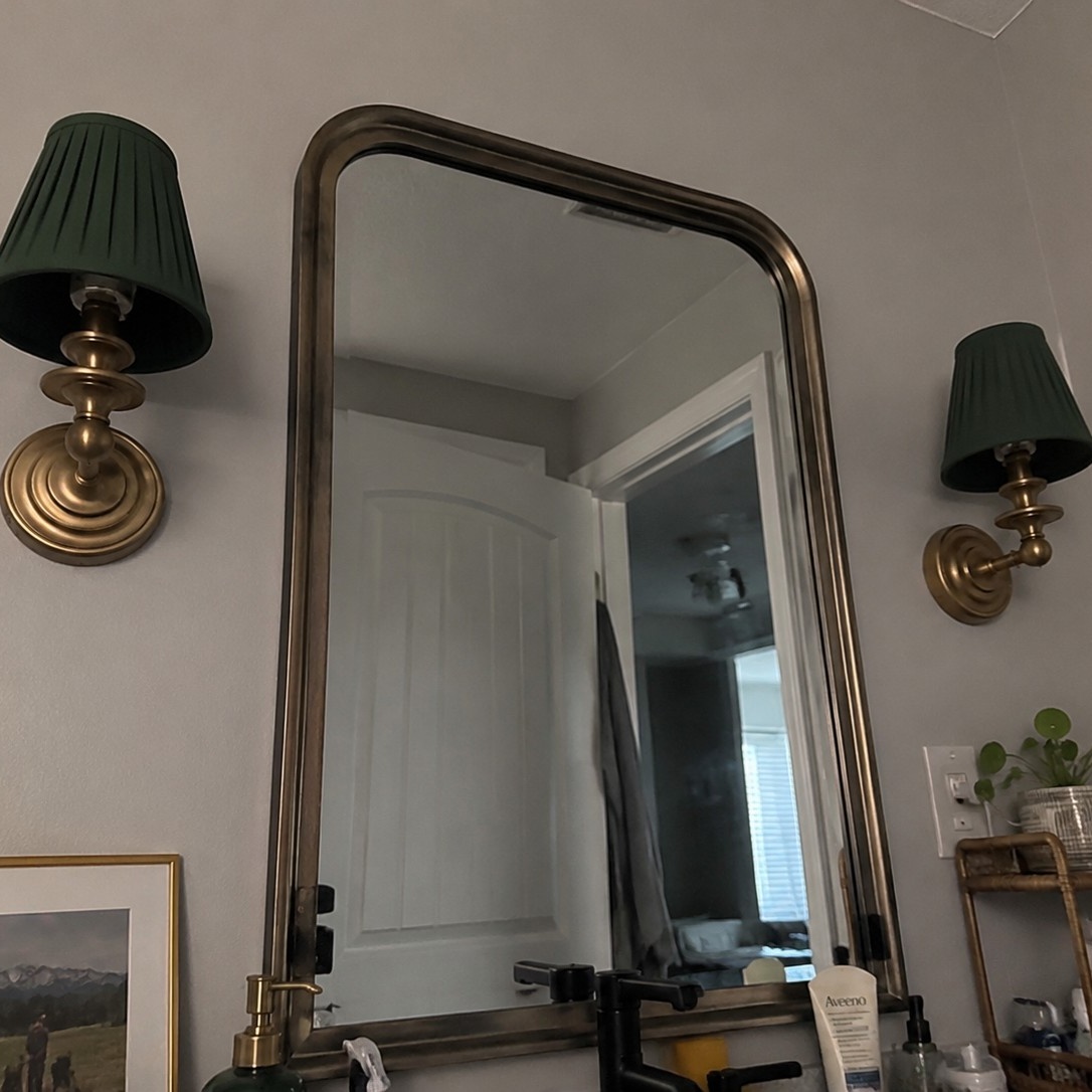 Customer review photo with wall sconce by mirror