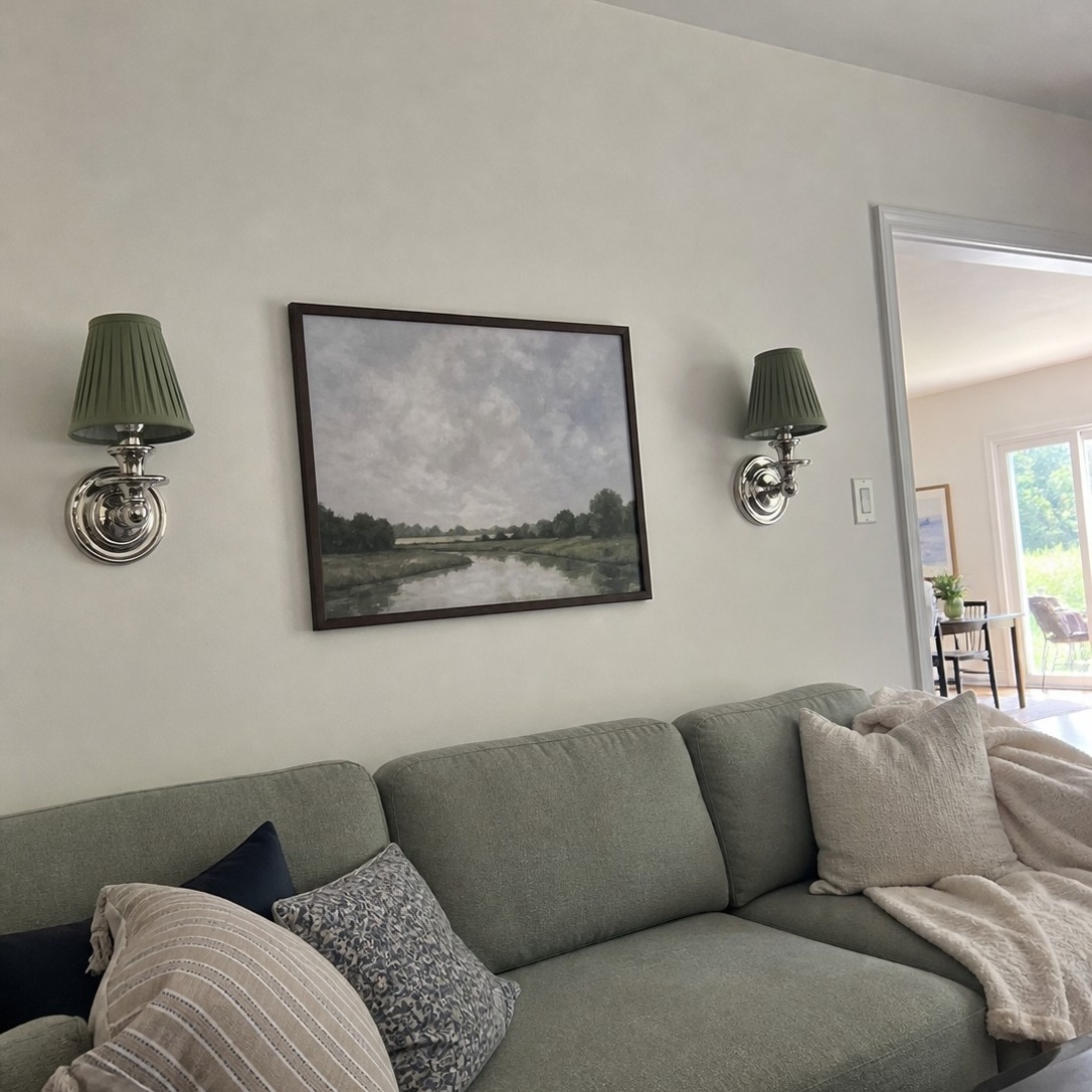 Customer review photo with wall sconce above sofa