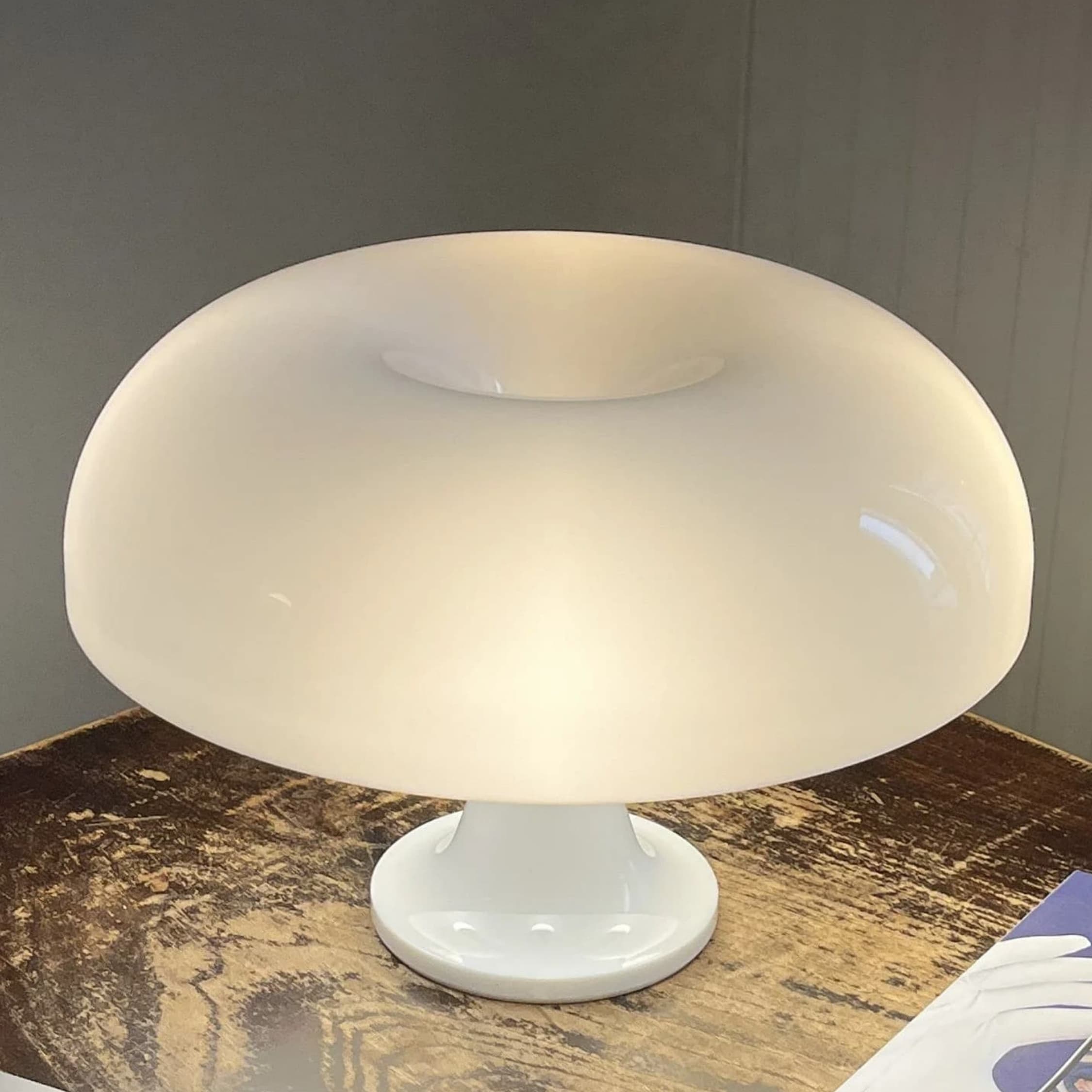 Mushroom table lamp switched on with soft glow